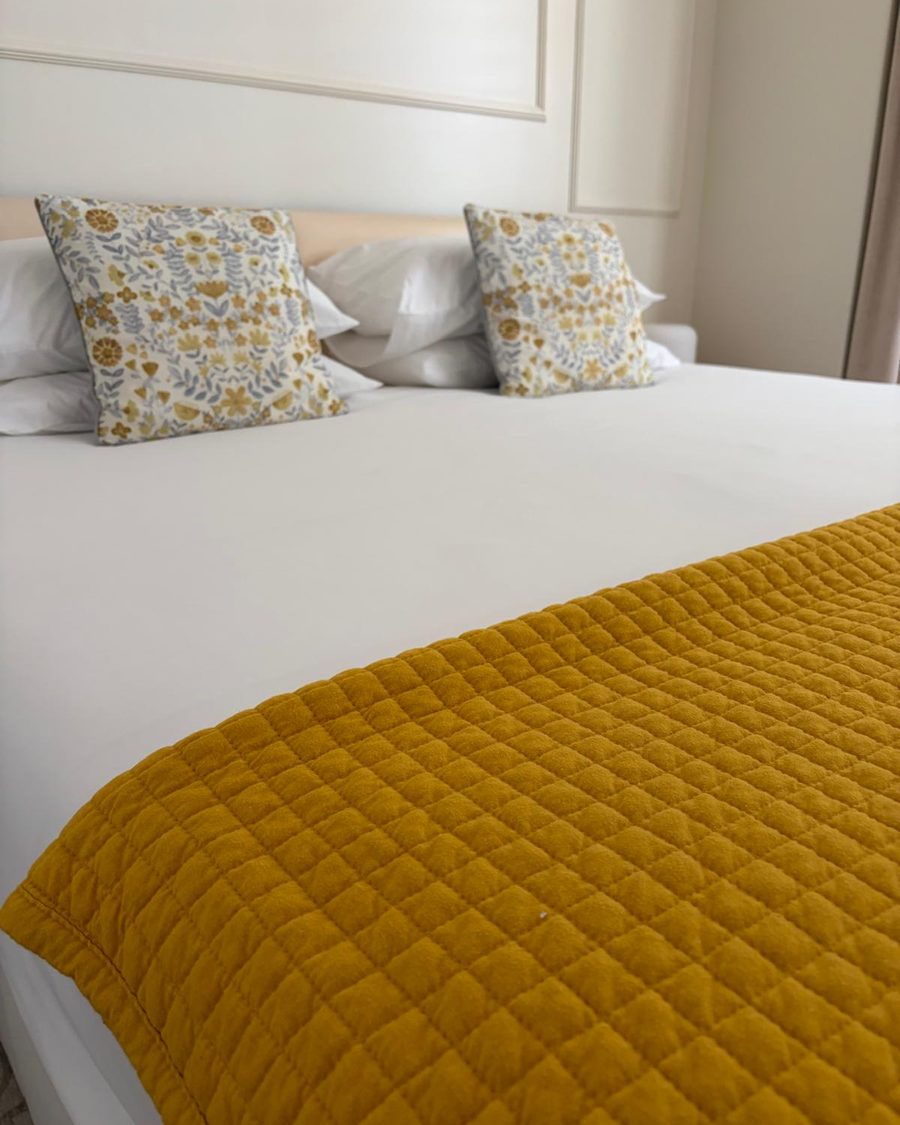 Freshly made bed with pressed linen after a Clanby changeover