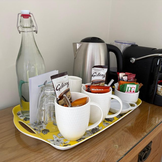 Hospitality tray restocked with tea, coffee and fresh water